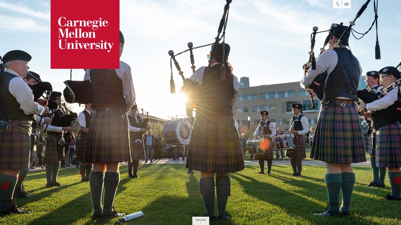 The 2019 opening picture at full width. The red wordmark square holds the top left corner over a photograph of the pipe band on the lawn, tartan kilts against low sun.